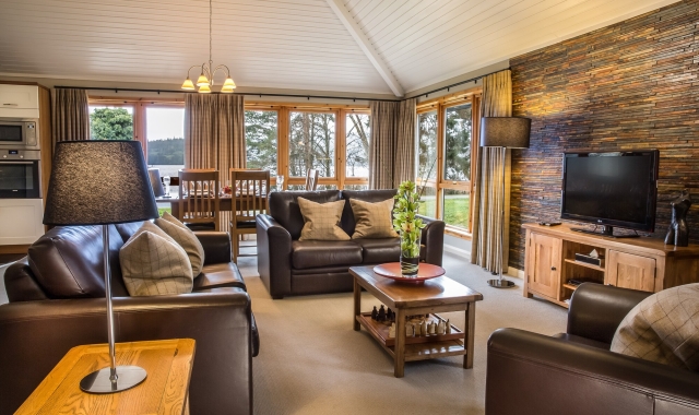 Luxury living room interior of a Cameron House lodge with loch views